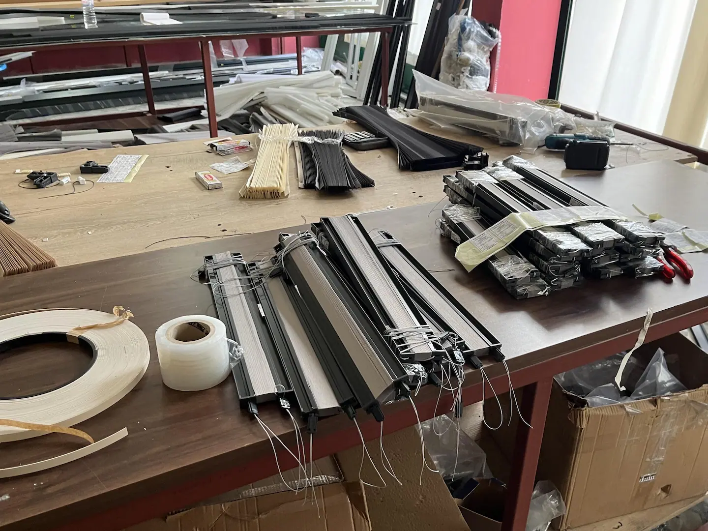 Pleated curtains being manufactured by hand